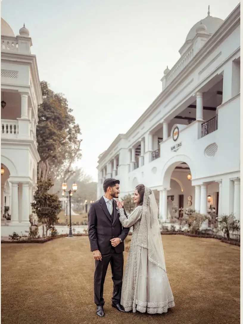 Bride and groom posing outside an elegant heritage building