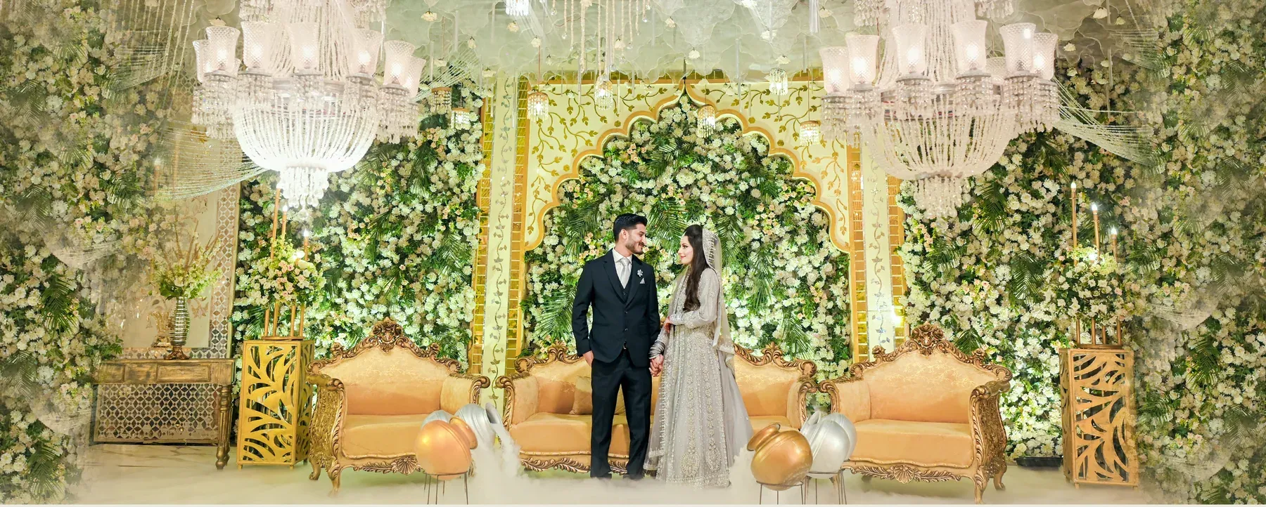 Bride and groom standing on a decorated wedding stage